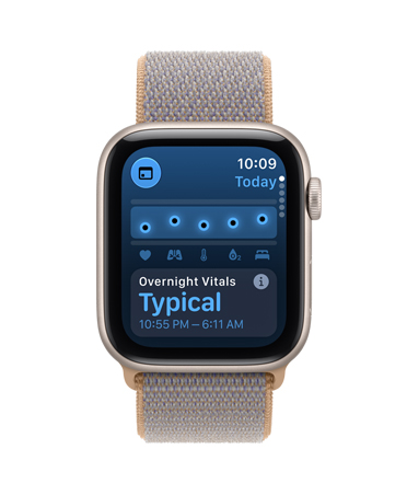 Apple Watch SE 3, aluminum case, starlight colour, screen shows health tracking (vitals), right side exterior, Digital Crown dial, Sport Loop band, chambray blue colour (light blue-grey)