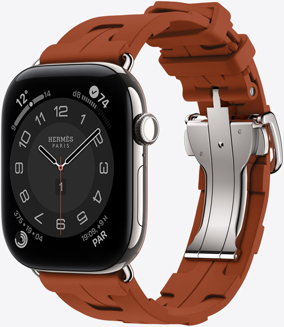 Apple Watch Hermès Series 12, quadrante analogico Circulaire (lancette dell’ora, dei minuti e dei secondi, complicazioni: Meteo, Rumore, anelli Attività e ora di Parigi), cassa in titanio color argento, lato destro, Digital Crown, tasto laterale, cinturino Simple Tour Kilim color Cuivre (marrone) in gomma sagomata con motivo geometrico e chiusura in metallo color argento