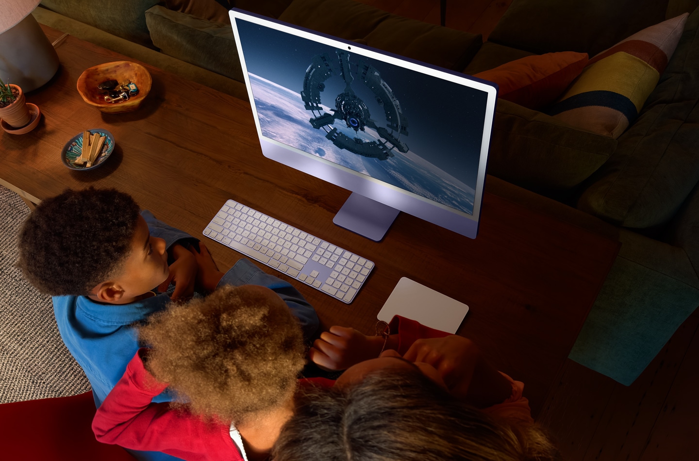 Three children watching WondLa show on iMac