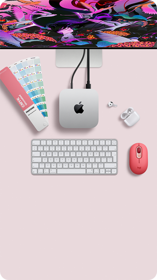 Mac mini, top, silver aluminum, rounded corners, glossy black Apple logo centered, connected by cord, Studio Display partially visible on top, AirPod 4, open, Pantone color swatches, and numeric keyboard and mouse