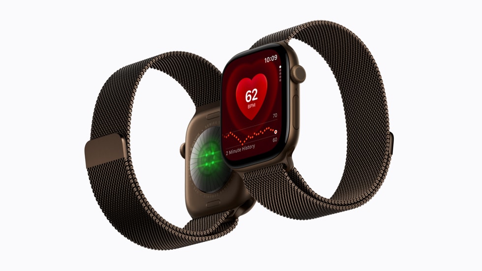 Deux Apple Watch Series 12 côte à côte. L’une montre la face arrière et ses capteurs, et l’autre montre la face avant et l’app Fréquence cardiaque.
