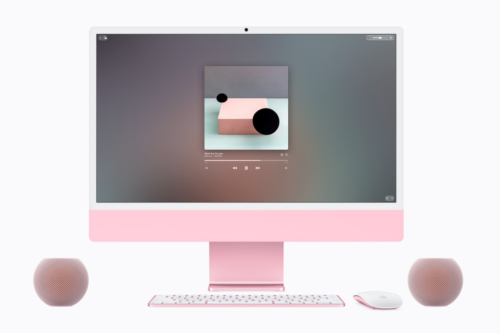 Two HomePod mini 2 speakers in pink alongside a coordinating iMac.