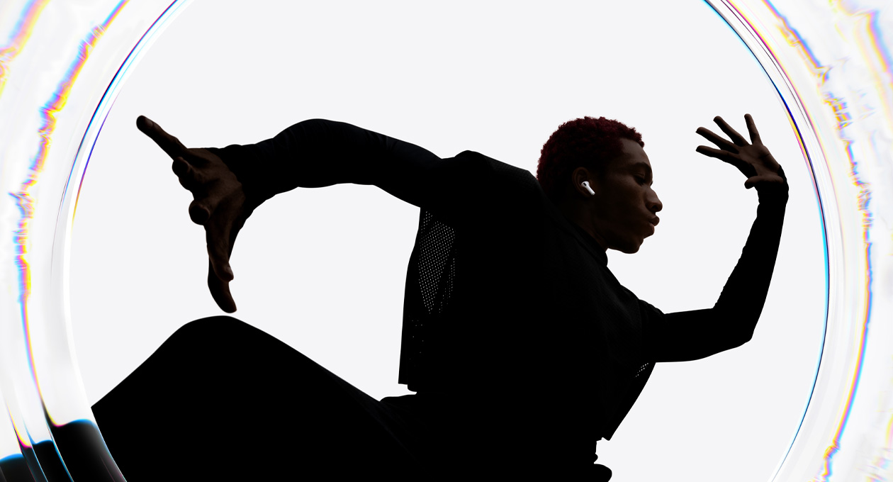 A dancer uses AirPods Pro 3 as they move to a beat with their arms spread wide