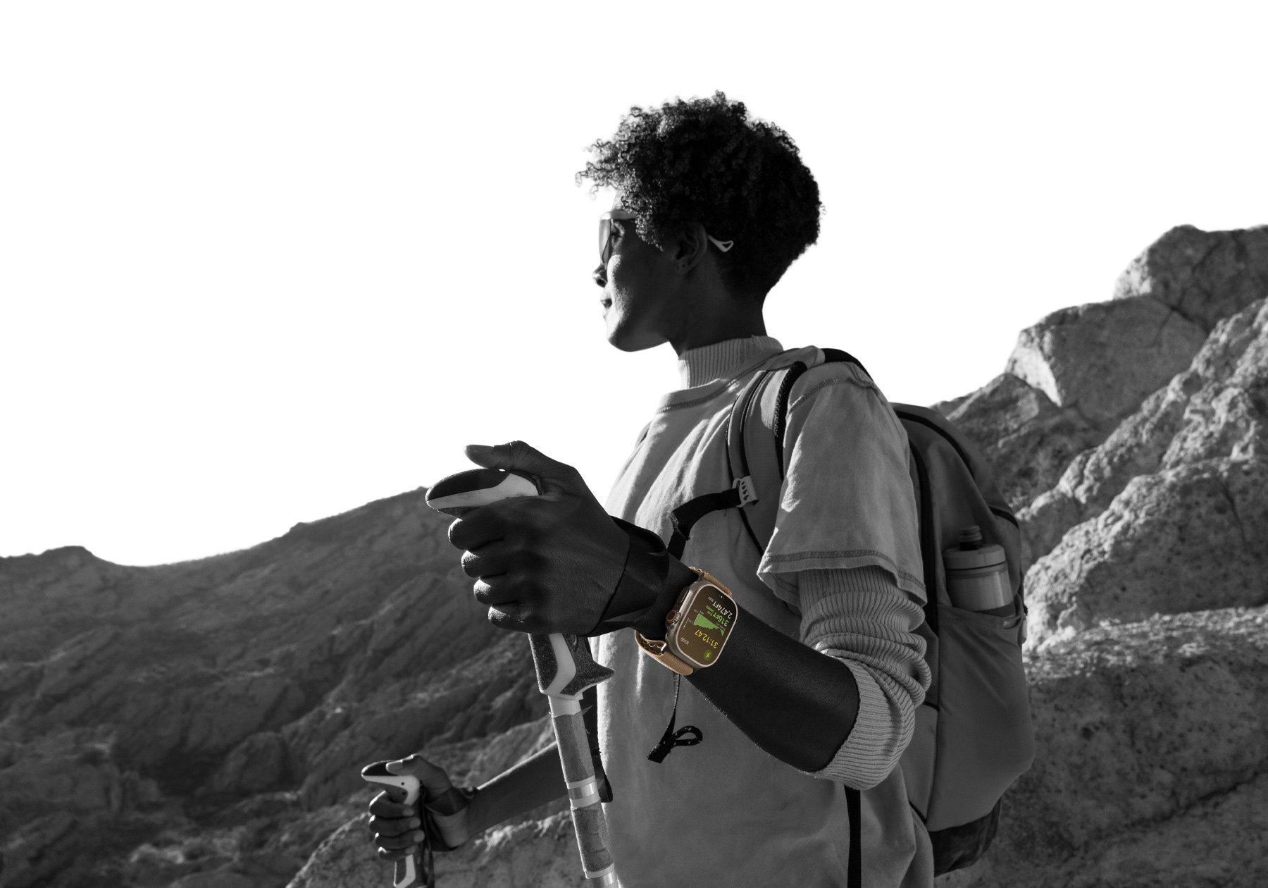一位佩戴 Apple Watch Ultra 4 的登山者在沙漠中遠足，螢幕顯示爬升高度指標