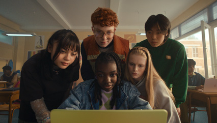 Five students collaborate on MacBook Neo in Citrus, engaged in a dynamic learning experience in the classroom.