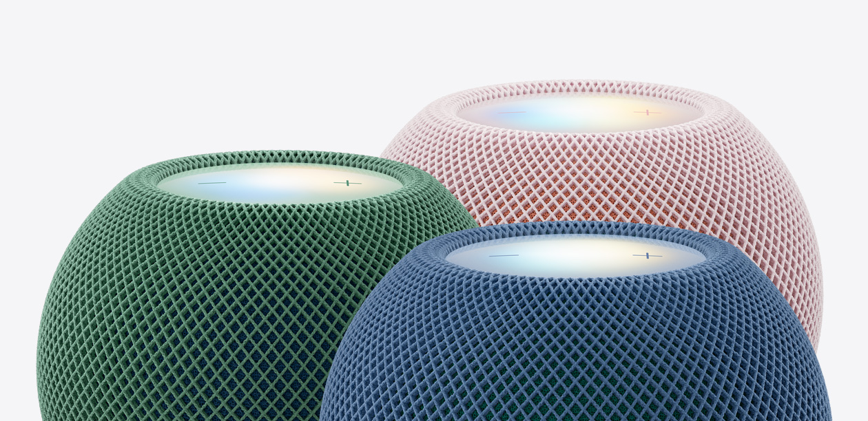 Three HomePod mini 2 speakers, green colour, blue colour, pink colour, close-up of top exteriors, woven acoustic mesh fabric, illuminated touch surfaces