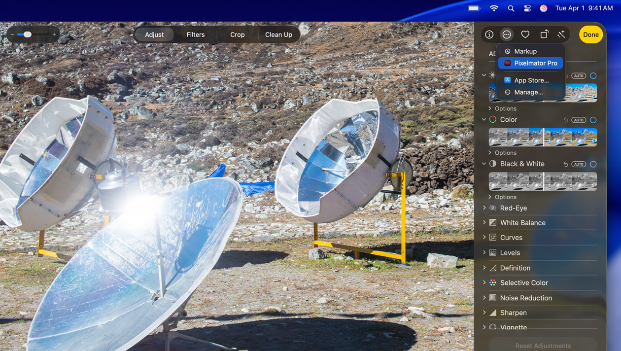 MacBook Pro 16 screen, photo of three silver space telescopes on ground, image editing tools